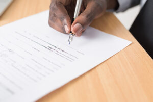 An image of a man signing a contract.