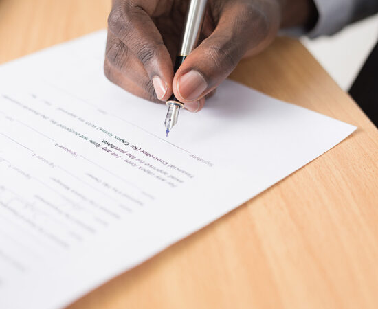An image of a man signing a contract.